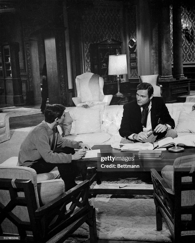 Adam West and Burt Ward Sitting and Talking in Regular Attire