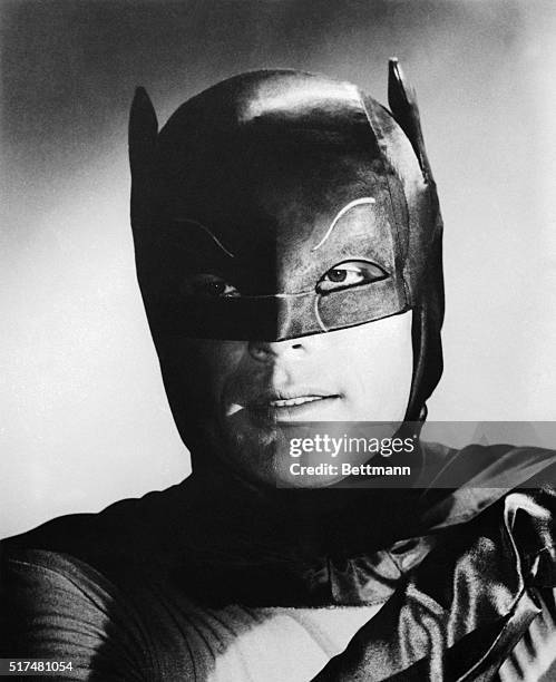 Adam West, is shown as his television character, "Batman." This is a still photo from the television show Batman.