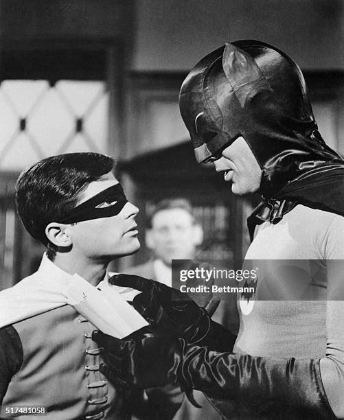 Adam West, and Burt Ward are shown as their television characters, "Batman" and Robin." This is a still photo from the television show Batman.