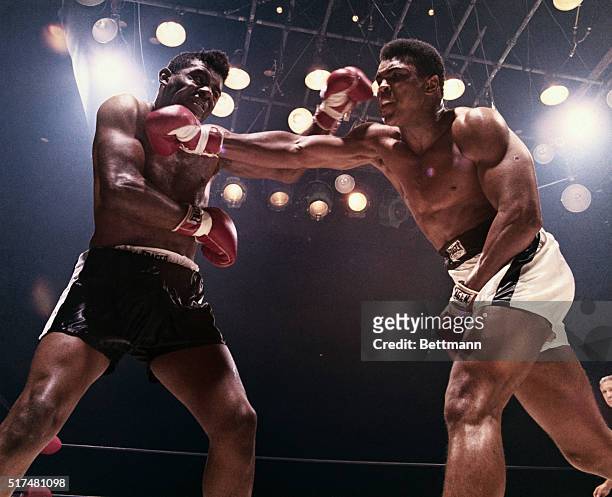 Floyd Patterson and Muhammad Ali each land a blow on the other. Ali won and retained his title of heavyweight champion.