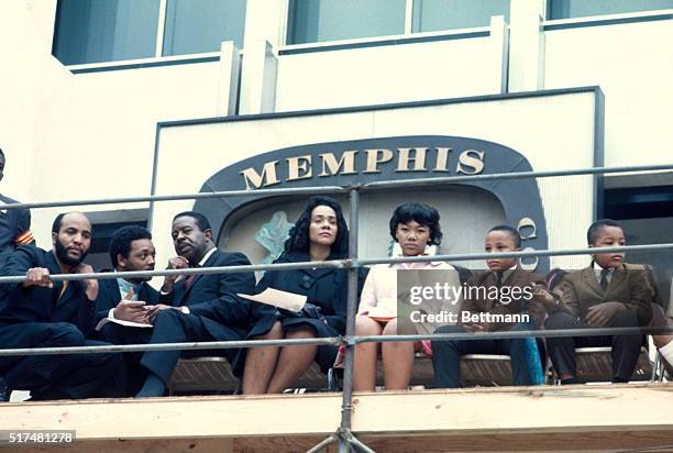 Mrs. Martin Luther King, Jr., sitting on a platform outside City Hall during three-hour rally which followed the memorial march in tribute to the...