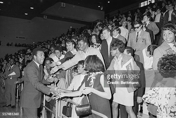 Former world heavyweight champion Cassius Clay, who calls himself Muhammad Ali, whoops it up with enthusiastic students at a rally on the St. John's...