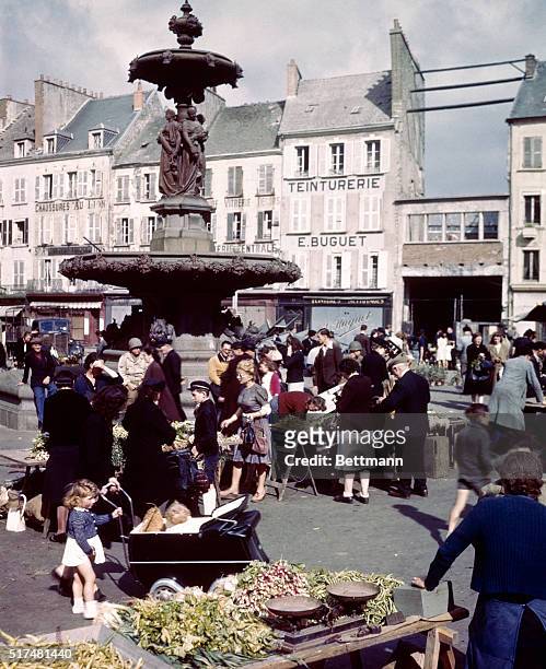 General view of the market in the public square. Shortly after the Germans were driven out of the port city, the people returned to resume normal...