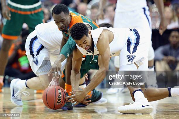 Phil Booth of the Villanova Wildcats and Sheldon McClellan of the Miami Hurricanes battle for a loose ball during the 2016 NCAA Men's Basketball...