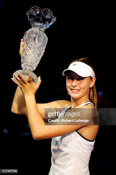 Maria Sharapova of Russia poses with the championship trophy after defeating Serena Williams in the finals of the WTA Tour Championship Tournament at...