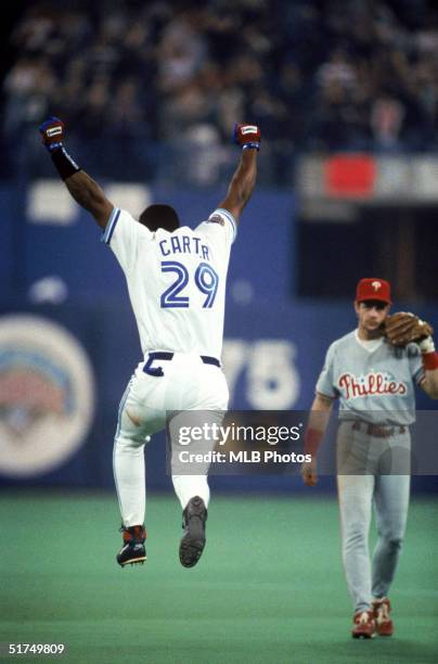 Joe Carter of the Toronto Blue Jays celebrates after hitting a three-run home run off of pitcher Mitch Williams of the Philadelphia Phillies to win...