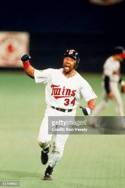 Kirby Puckett of the Minnesota Twins celebrates as he rounds the bases after hitting the game winning home run in the eleven inning of the 1991 World...
