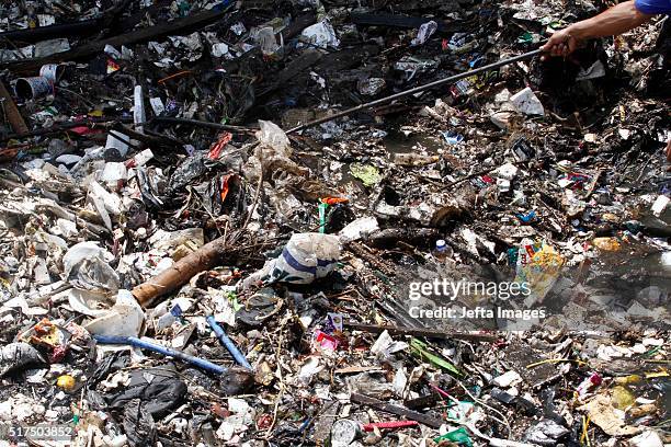 An Indonesian worker removes plastic and other garbage clogging the Citarum river on March 25, 2016 in West Java, Indonesia. Countless toilets and...