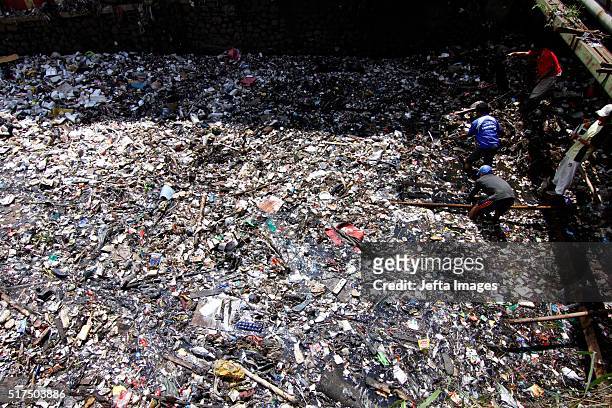 An Indonesian worker removes plastic and other garbage clogging the Citarum river on March 25, 2016 in West Java, Indonesia. Countless toilets and...