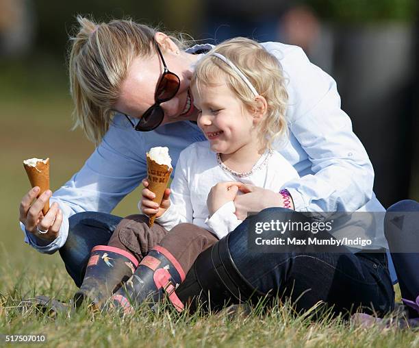 Autumn Phillips and daughter Isla Phillips eat ice creams as they watch the show jumping during the Gatcombe Horse Trails at Gatcombe Park,...