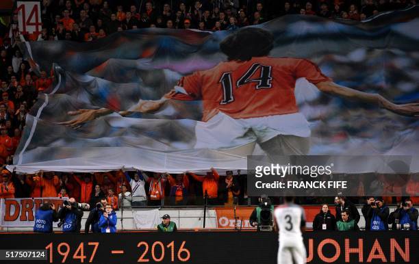 Large banner is displayed during a standing ovation in honour of late Dutch football legend Johann Cruyff during a pause in the 14th minute of the...