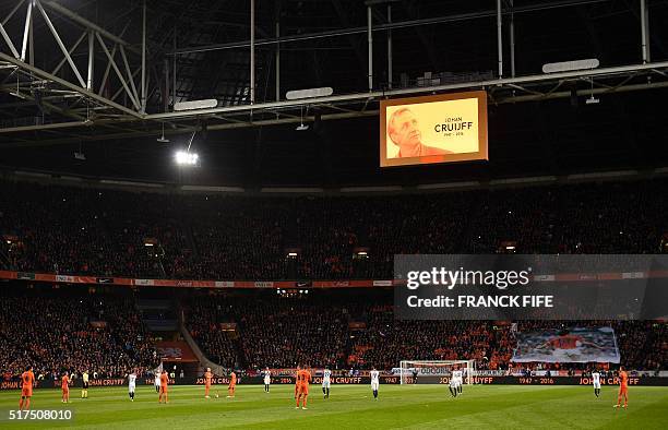 Portrait of late Dutch football legend Johann Cruyff is displayed on a screen during a standing ovation in his honour during a pause in the 14th...