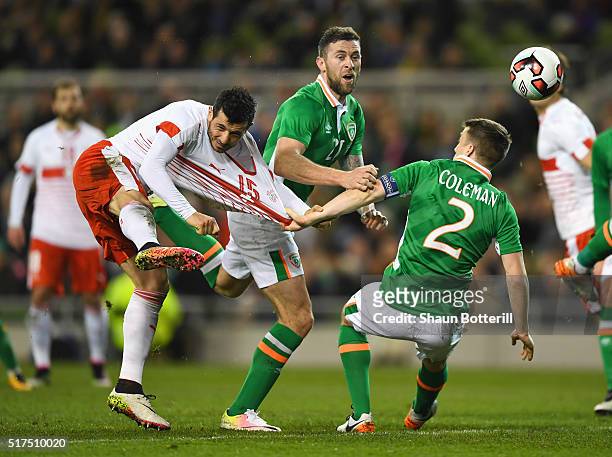 Blerim Dzemaili of Switzerland is challenged by Daryl Murphy and Seamus Coleman of Republic of Ireland during the International Friendly match...