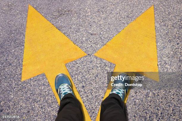 feet and words work and life  painted on road - opposite direction stockfoto's en -beelden