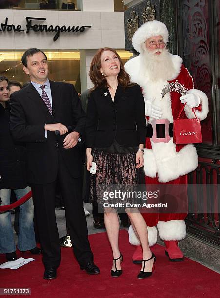 President and CEO of Cartier Stanislas de Quercize poses with Santa Claus and actress Julianne Moore attends the 25th anniversary of the Cartier...