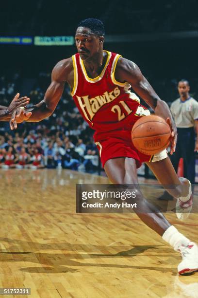Dominique Wilkins of the Atlanta Hawks dribble drives to the basket against the Miami Heat during the NBA game on November 19, 1993 in Miami,...