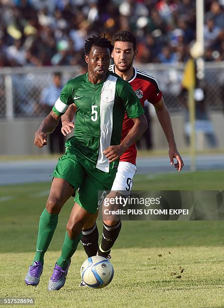 Egypt's forward Ahmed Hassan Koka vies with Nigeria's midfielder Ambrose Efe during the African Cup of Nations qualification match between Egypt and...