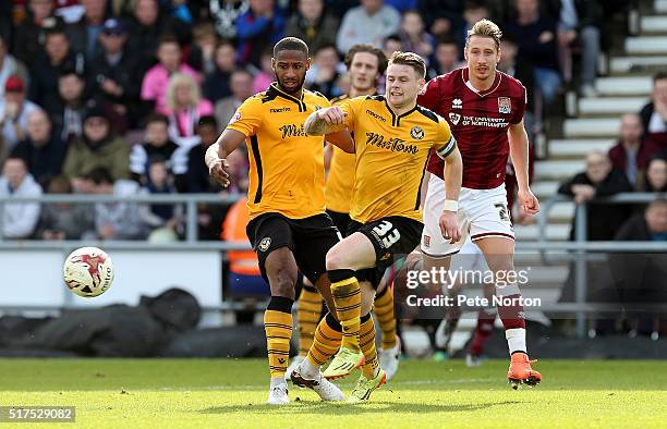 Mark Byrne and Janoi Donacien of Newport County look to the ball with Lee Martin of Northampton Town during the Sky Bet League Two match between...