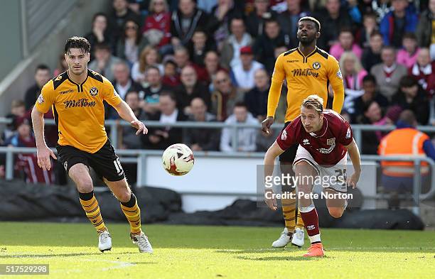 Lee Martin of Northampton Town looks to the ball with Andrew Hughes of Newport County during the Sky Bet League Two match between Northampton Town...