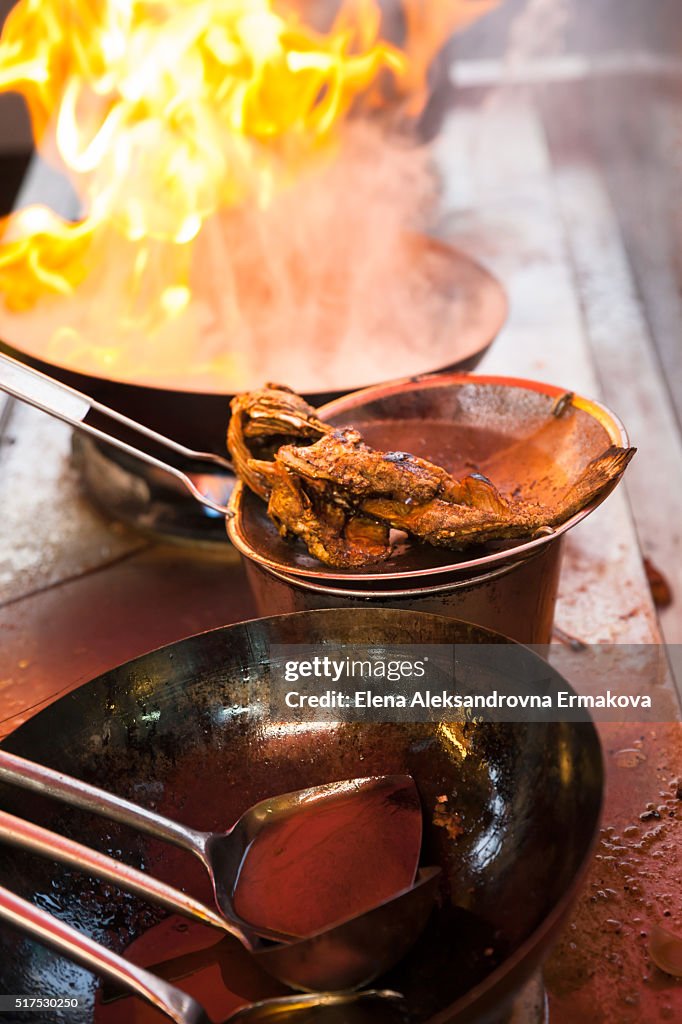 Fish deep-fried in asian wok on the street food stall, Penang, Malaysia