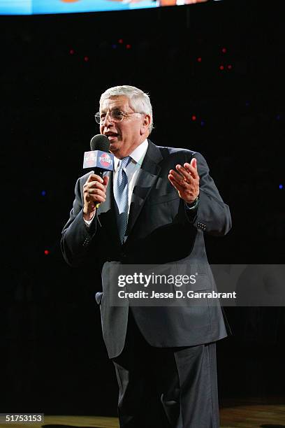 Commissioner David Stern congratulates the Detroit Pistons during the championship ring ceremony prior to Detroit facing the Houston Rockets on...