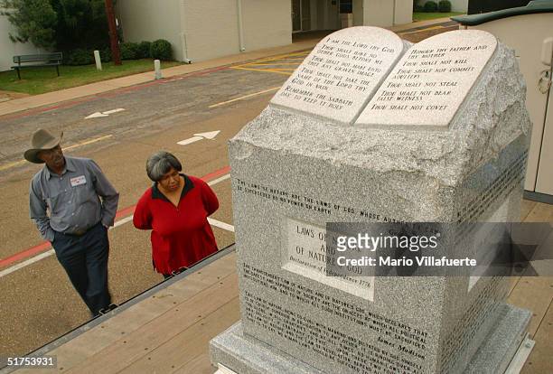 Couple views the granite Ten Commandments monument that was removed in 2003 from the Alabama Judicial Building November 16, 2004 in Longview, Texas....