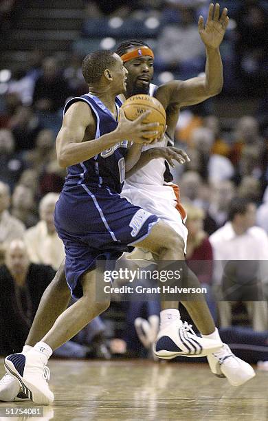 Howard Eisley of the Utah Jazz draws a blocking foul as he collides with Melvin Ely of the Charlotte Bobcats on November 16, 2004 at the Charlotte...