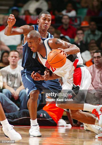 Keith Bogans of the Charlotte Bobcats drives to the basket against Howard Eisley of the Utah Jazz November 16, 2004 at the Charlotte Coliseum in...