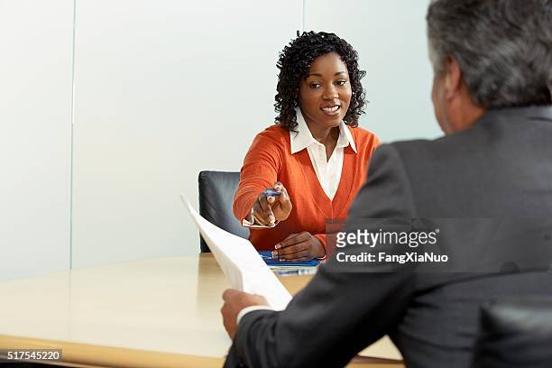businesspeople in a meeting - woman making a deal stock pictures, royalty-free photos & images