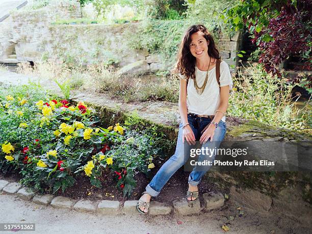 pretty smiling woman sitting in garden - flower necklace stock pictures, royalty-free photos & images