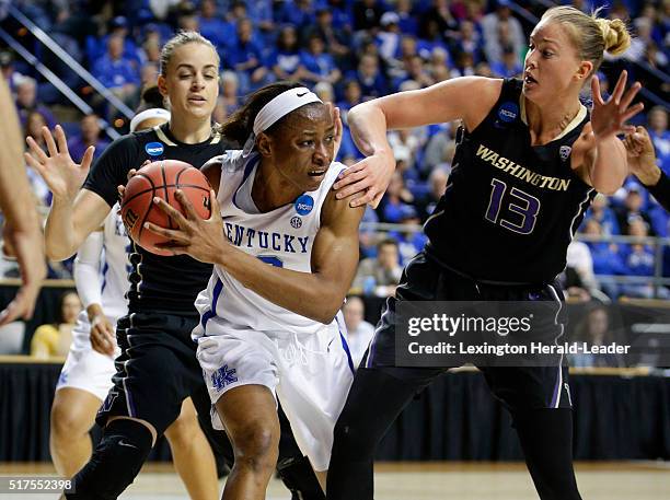 Kentucky's Evelyn Akhator, middle, looks to pass after grabbing a rebound in front of Washington's Katie Collier, right, in the third round of the...