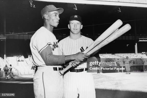 American professional baseball players and hall of fame members Ernie Banks of the Chicago Cubs and Mickey Mantle of the New York Yankees, the...