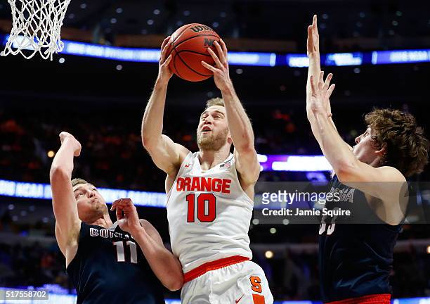 Trevor Cooney of the Syracuse Orange shoots against Domantas Sabonis and Kyle Wiltjer of the Gonzaga Bulldogs in the first half during the 2016 NCAA...