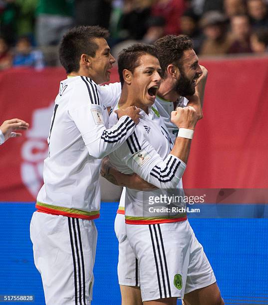 Javier "Chicharito" Herhandez of Mexico is congratulated by teammates Javier Aquino and Miguel Layun of Mexico after scoring a goal against Canda...