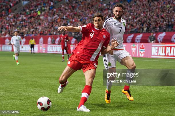 Dejan Jakovic of Canada battles Miguel Layun of Mexico for the ball during FIFA 2018 World Cup Qualifier soccer action at BC Place on March 25, 2016...