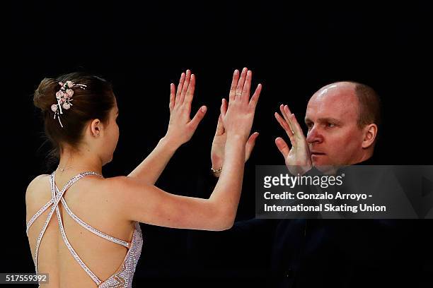 Michaela Du Toit from South Africa clashes hands with her coach prior to start her show the Ladie's short program of the ISU World Junior Figure...