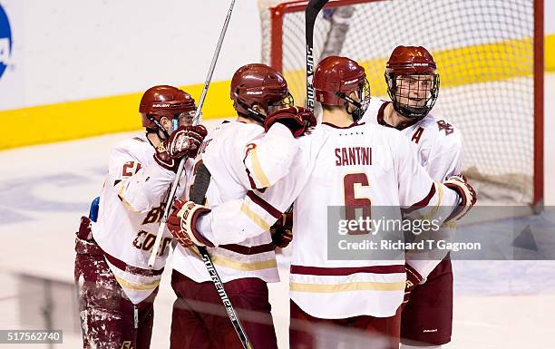 Austin Cangelosi of the Boston College Eagles celebrates his second goal of the game against the Harvard Crimson with teammates Chris Calnan, Steve...