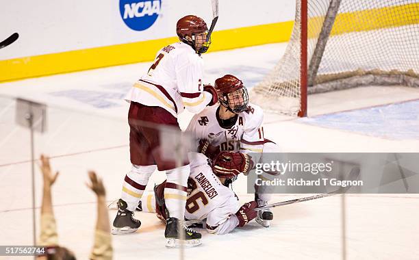 Austin Cangelosi of the Boston College Eagles celebrates his second goal of the game against the Harvard Crimson with teammates Chris Calnan and...