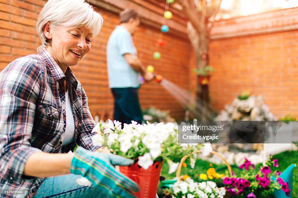 Mature Couple Planting In Their Backyard.