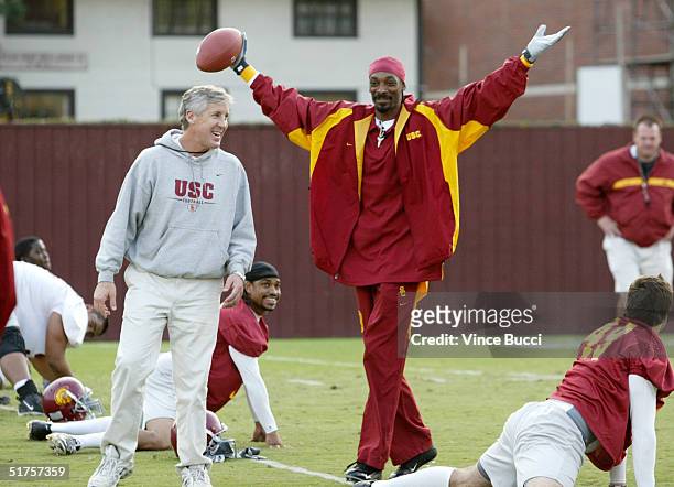 Rap music artist Snoop Dogg greets members of the University of Southern California football team while filming the mtvU show "Stand In" on November...