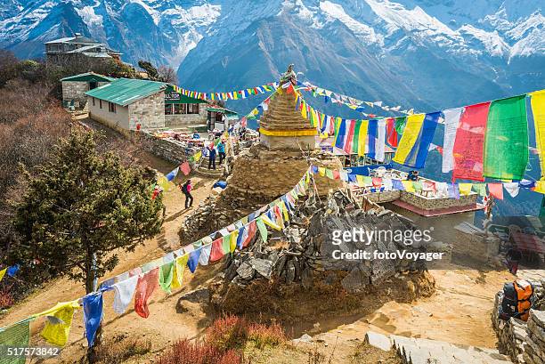 hikers trekking colourful buddhist prayer flags everest trail himalayas nepal - nepal stock pictures, royalty-free photos & images