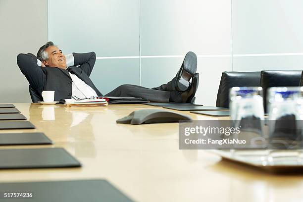 businessman in a conference room - feet on table bildbanksfoton och bilder