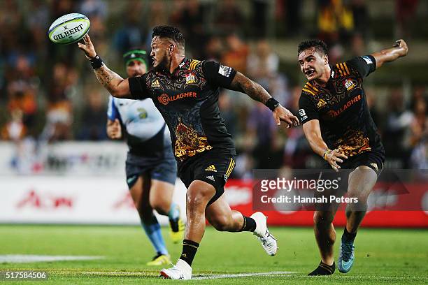 Hika Elliot of the Chiefs offloads the ball during the round five Super Rugby match between the Chiefs and the Western Force at FMG Stadium on March...
