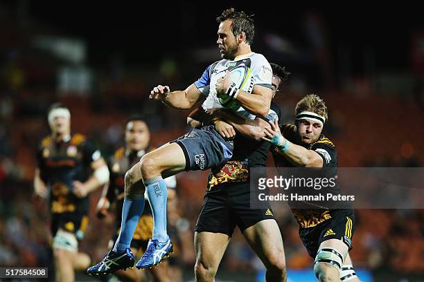 James Lowe of the Chiefs tackles Peter Grant of the Force during the round five Super Rugby match between the Chiefs and the Western Force at FMG...