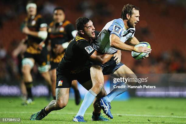 James Lowe of the Chiefs tackles Peter Grant of the Force during the round five Super Rugby match between the Chiefs and the Western Force at FMG...