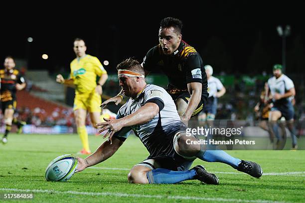 Brynard Stander of the Force gathers the ball ahead of James Lowe of the Chiefs during the round five Super Rugby match between the Chiefs and the...