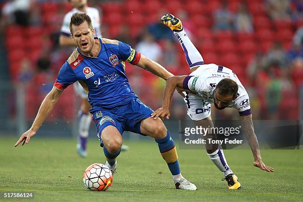 Diego Castro of the Glory contests the ball with Nigel Boogaard of the Jets during the round 25 A-League match between the Newcastle Jets and the...