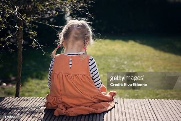 sad girl sitting with head down - sad children only stock pictures, royalty-free photos & images