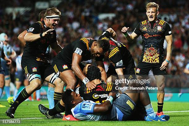 Charlie Ngatai of the Chiefs celebrates with Sam Cane of the Chiefs, Seta Tamanivalu of the Chiefs and Damian McKenzie of the Chiefs after scoring a...