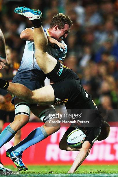 Angus Cottrell of the Force lifts Sam McNicol of the Chiefs in a tackle resulting in a yellow card during the round five Super Rugby match between...